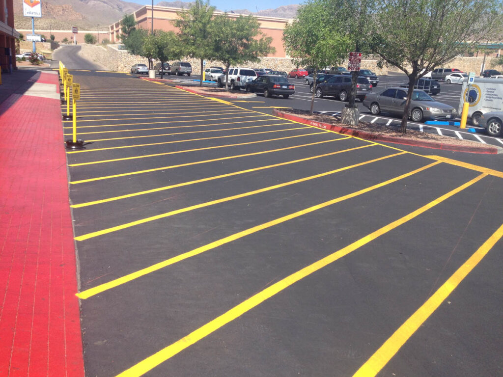 A recently-paved parking lot with yellow paint in El Paso