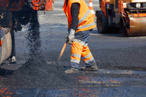 A professional pouring fresh asphalt