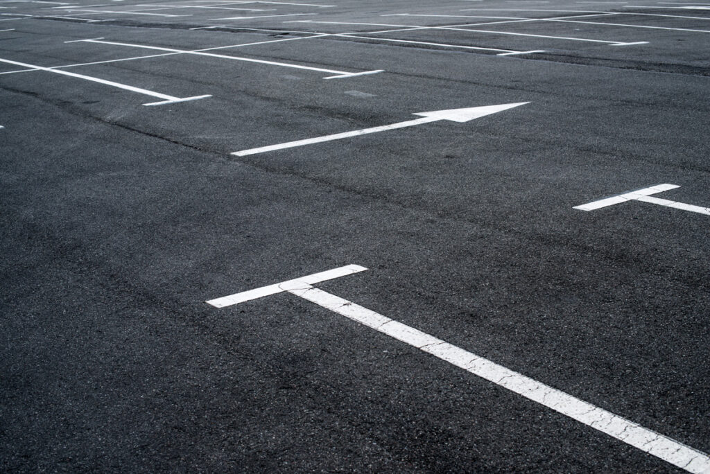 Close-up image of freshly painted parking lot stripes in an El Paso parking lot.