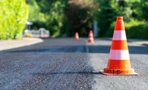 Fresh asphalt on an El Paso road with orange cones next to it.